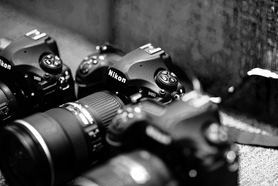 Close-up of professional Nikon camera gear, emphasizing readiness, technical precision, and high-caliber execution.